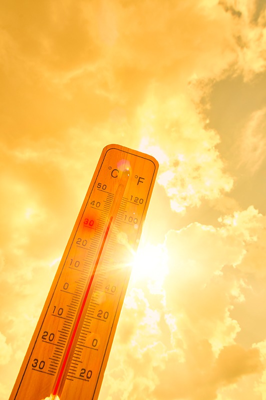 Thermometer against background hot, summer yellow sun.Hot weather and high air temperature.